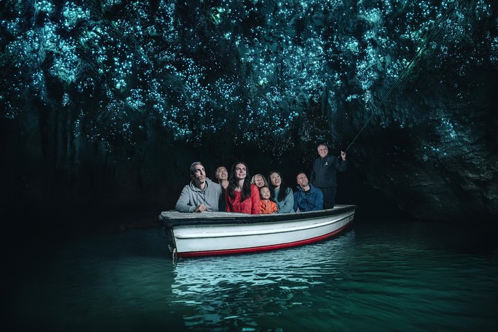 Glide through the serene glow worm caves surrounded by mesmerizing light displays above while creating unforgettable memories with fellow travelers on this unique guided boat tour.